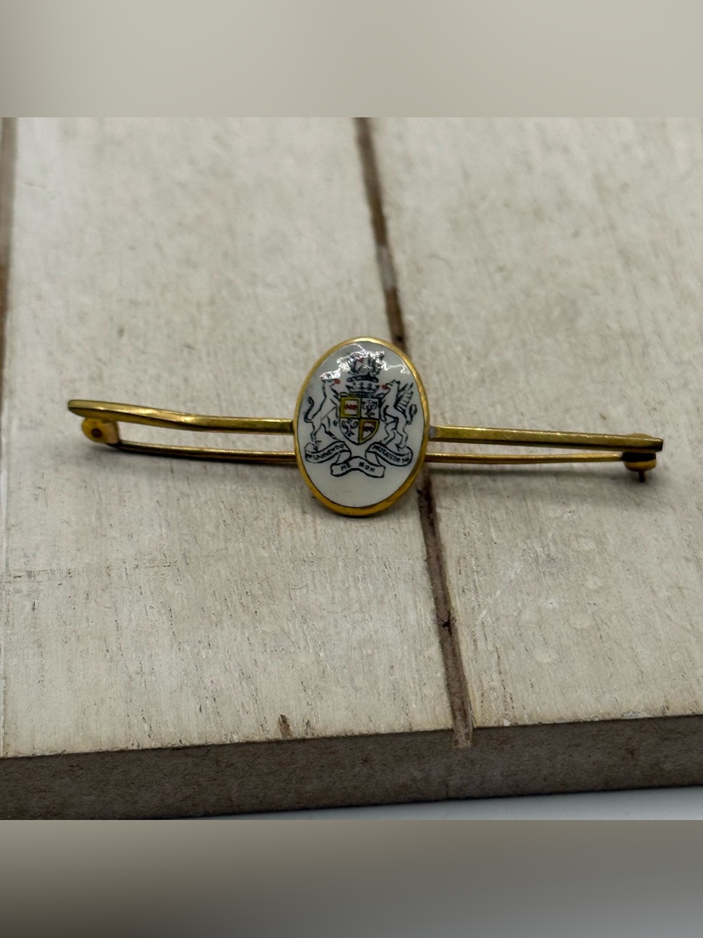 Gold-Tone White Enamel Crest brooch